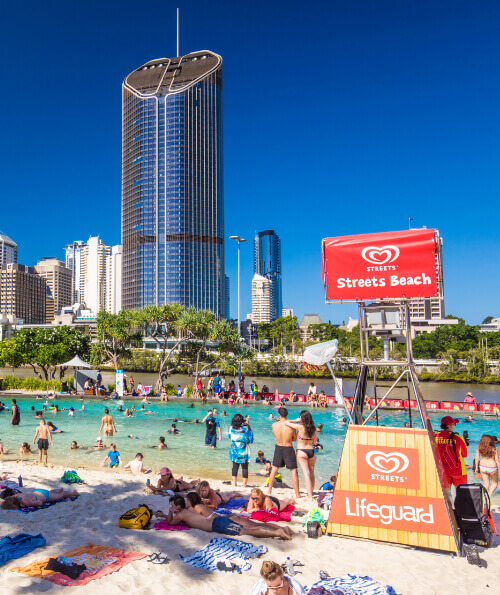 Crowds at Streets Beach South Bank with Brisbane CBD towers behind