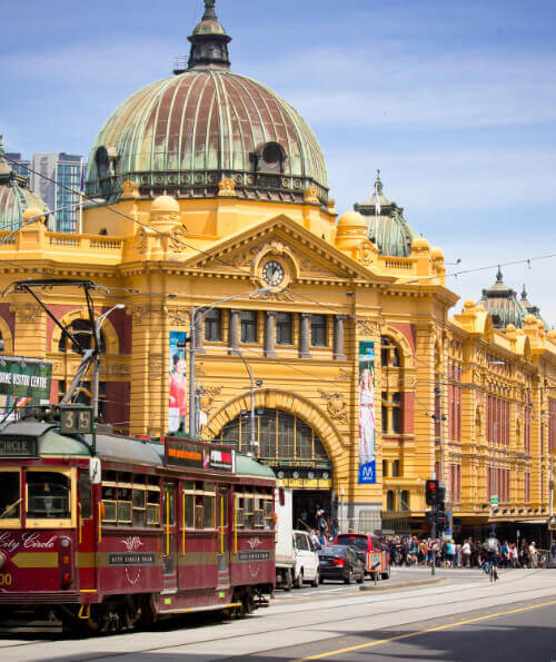 Flinders Street Station and City Circle tram on a sunny day in Melbourne CBD
