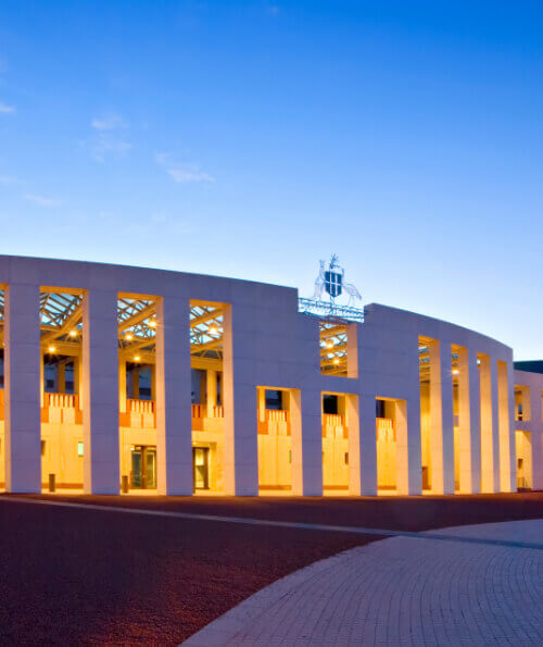 Australian Parliament House Canberra illuminated at dusk